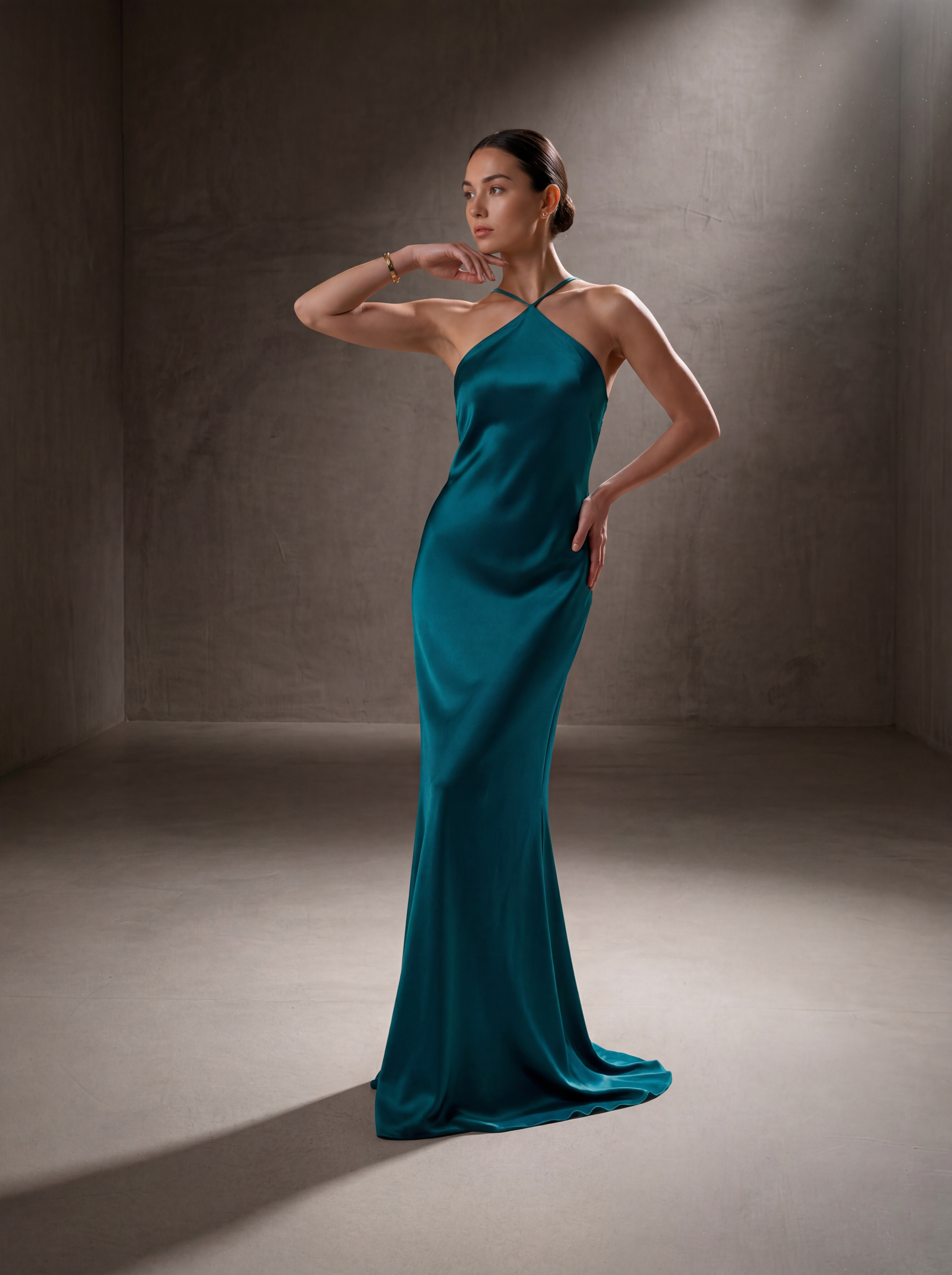 Woman wearing a Teal silk halter gown