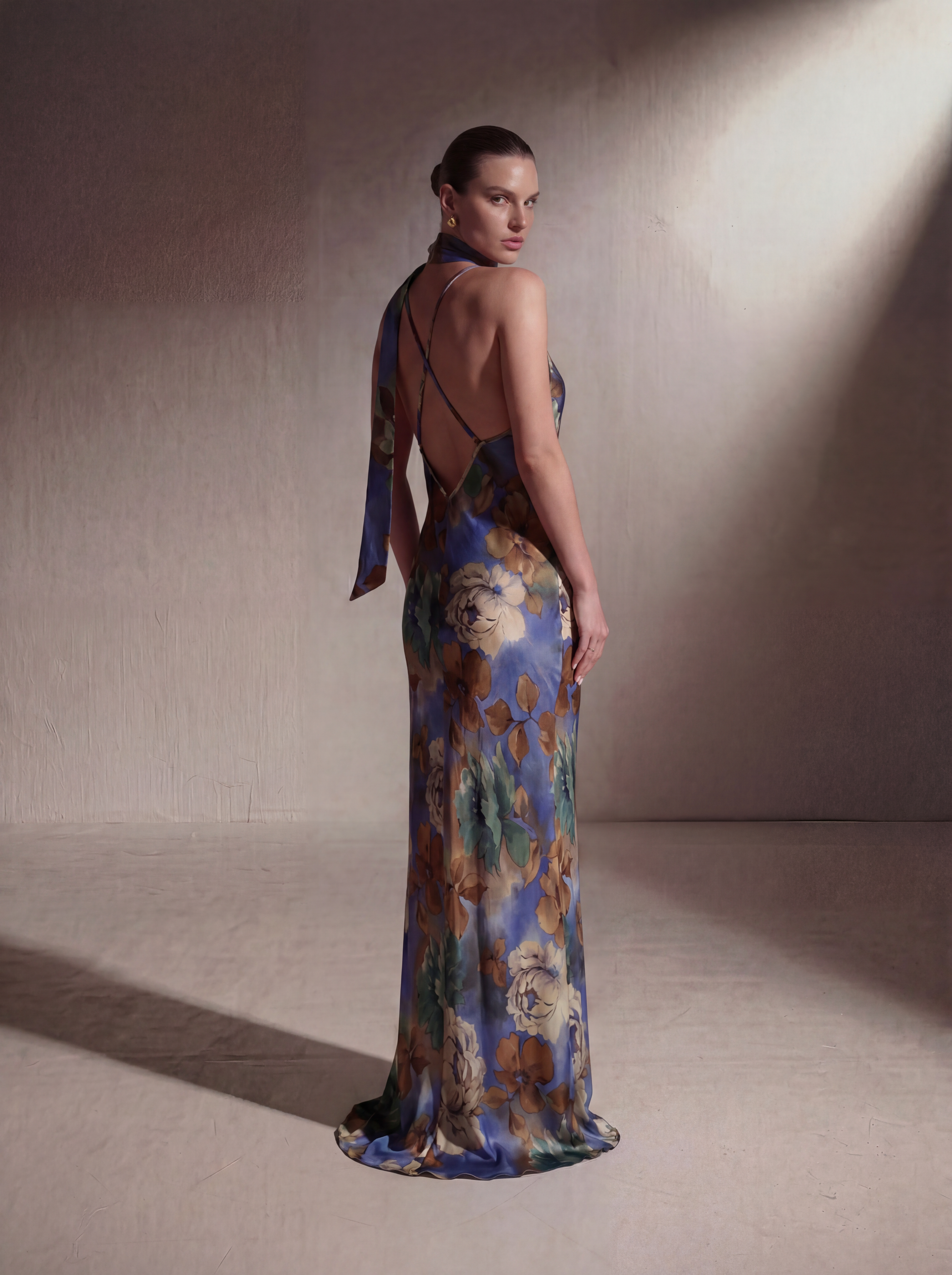 Woman wearing a Blue Floral silk slip gown, back view