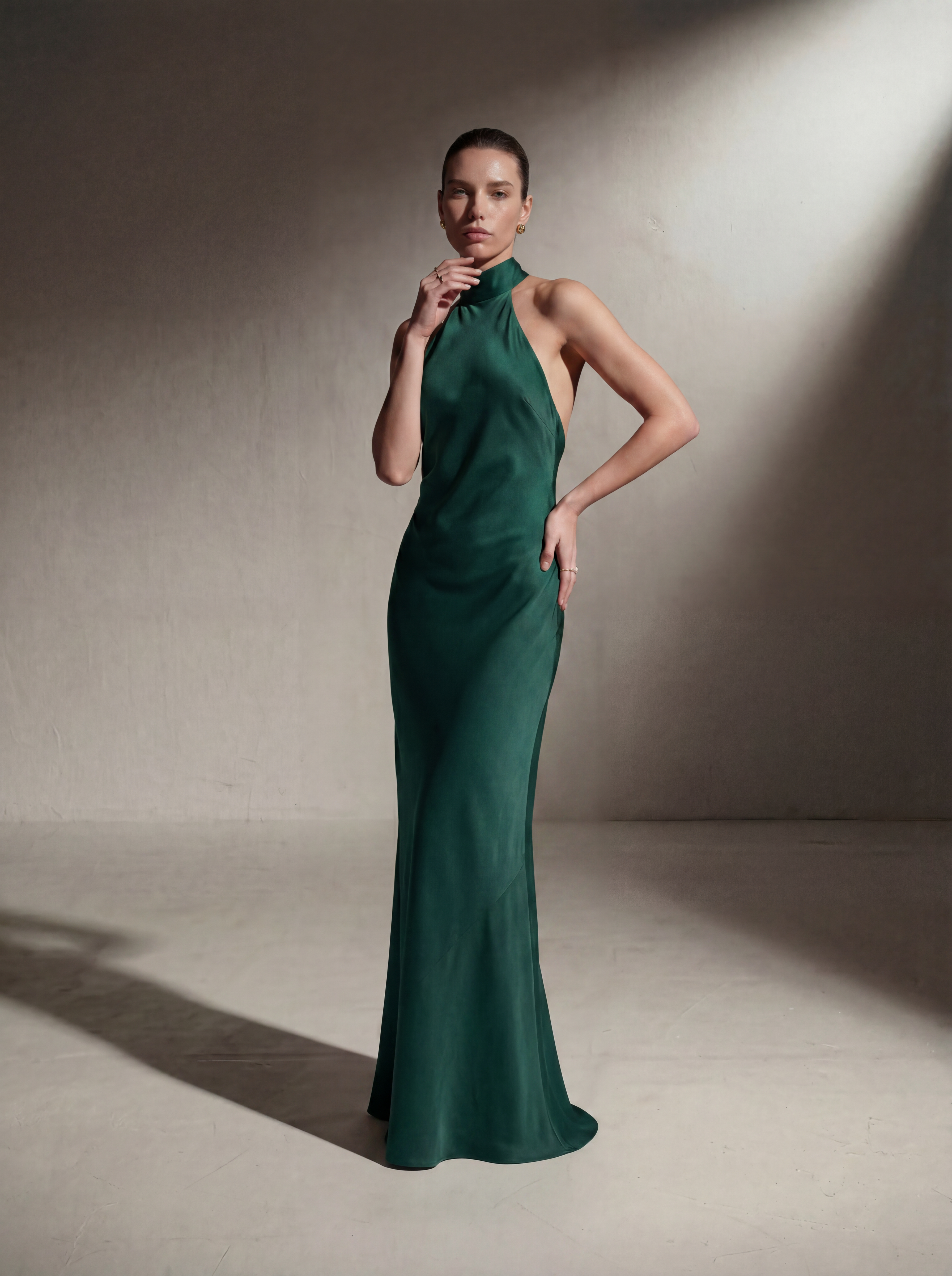 Woman wearing a Pine silk halter gown, front view