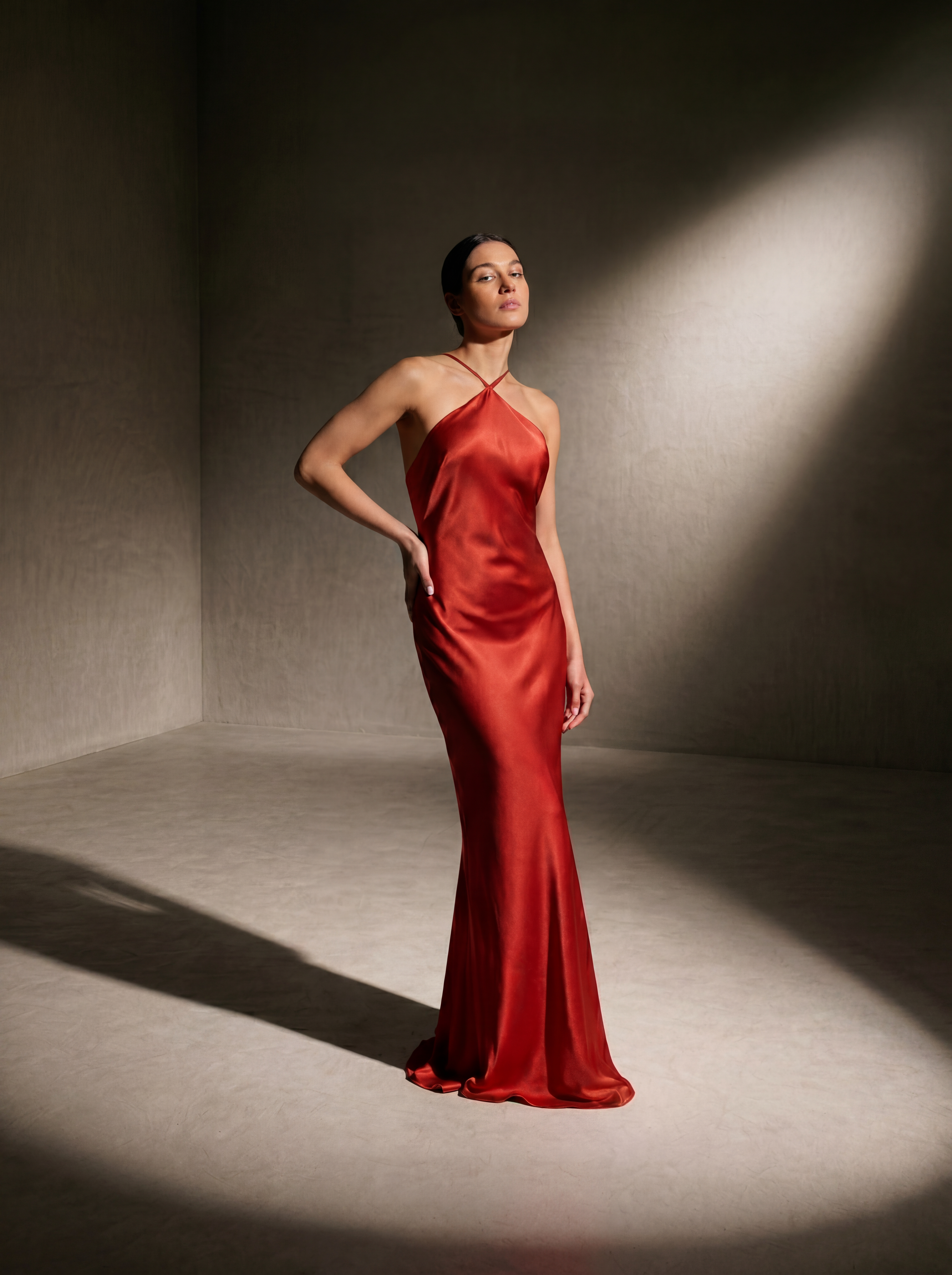 Woman wearing a Cayenne silk halter gown