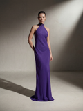 Woman wearing a Plum silk halter gown, front view