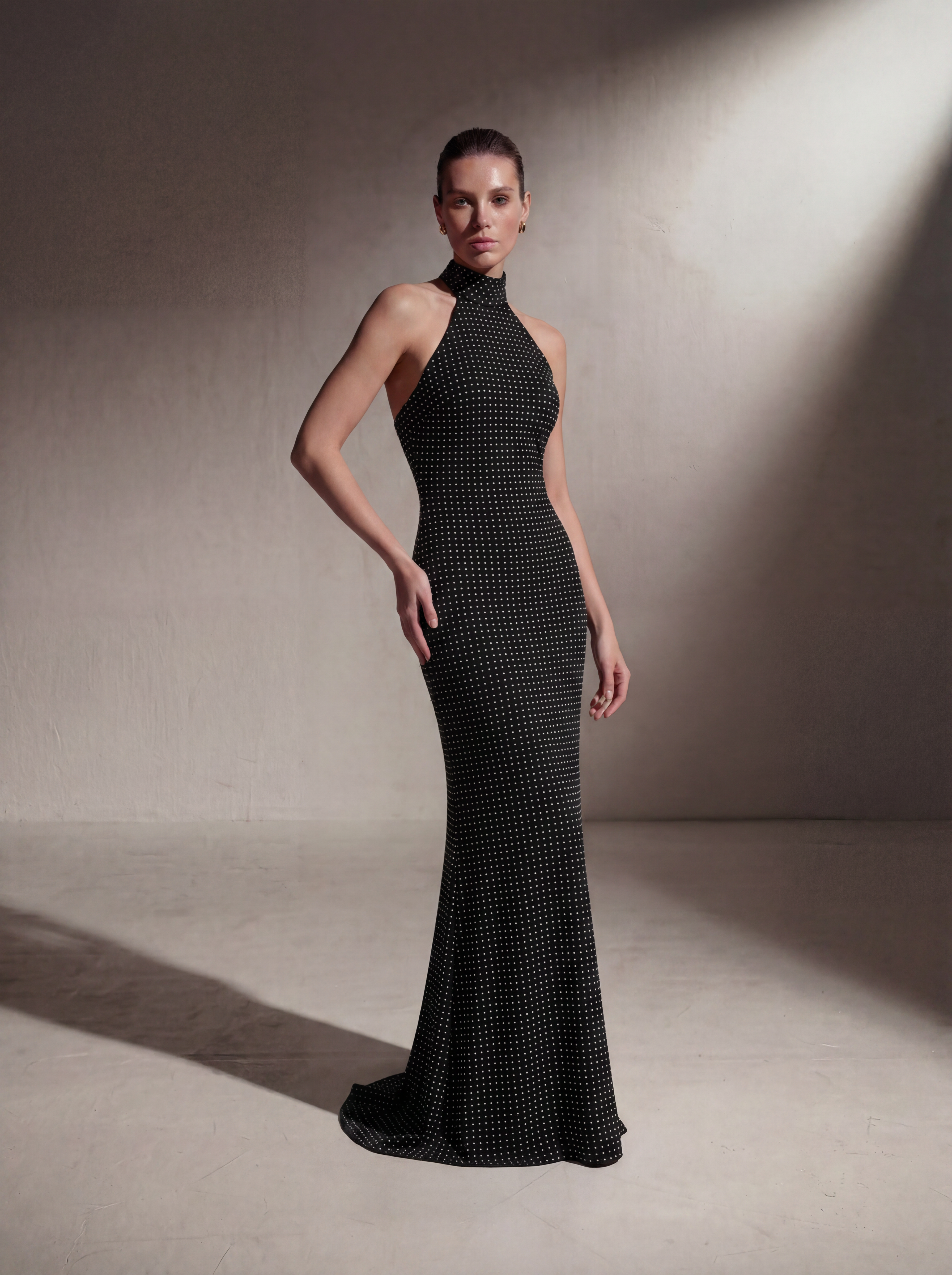 Woman wearing a Black Polka Dot silk halter gown