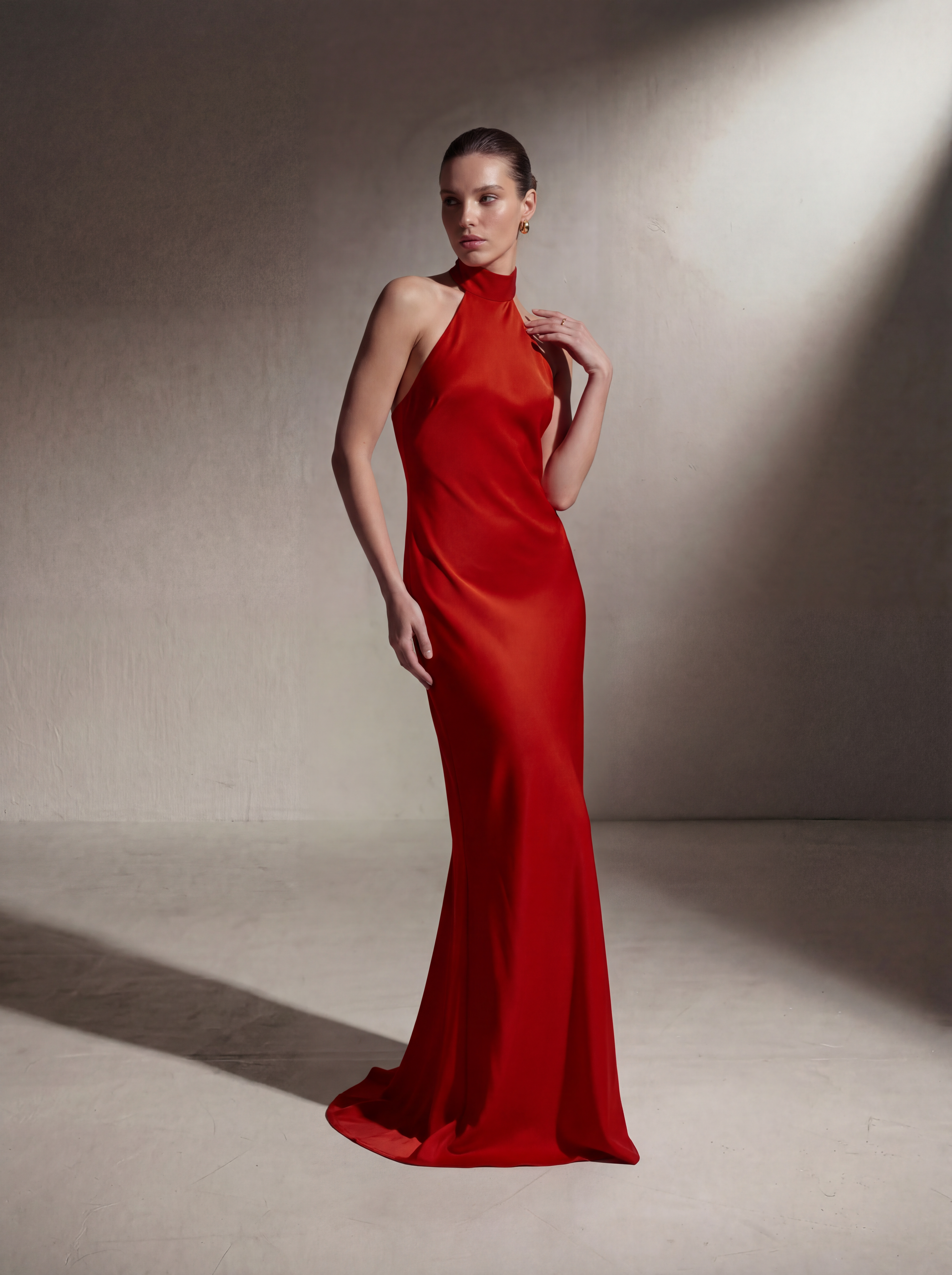 Woman wearing a Red silk halter gown, front view