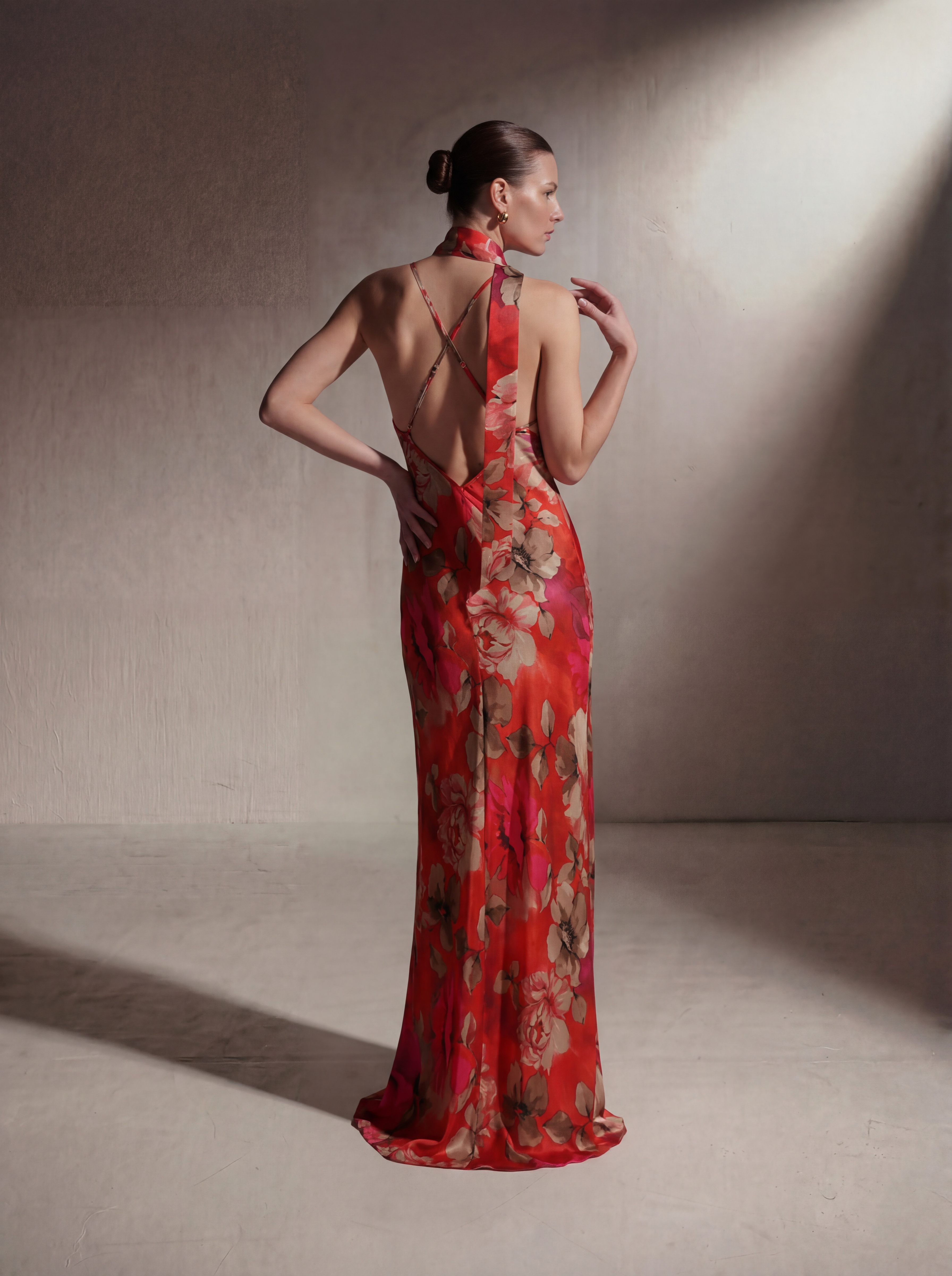 Woman wearing a Red Floral silk slip gown, back view