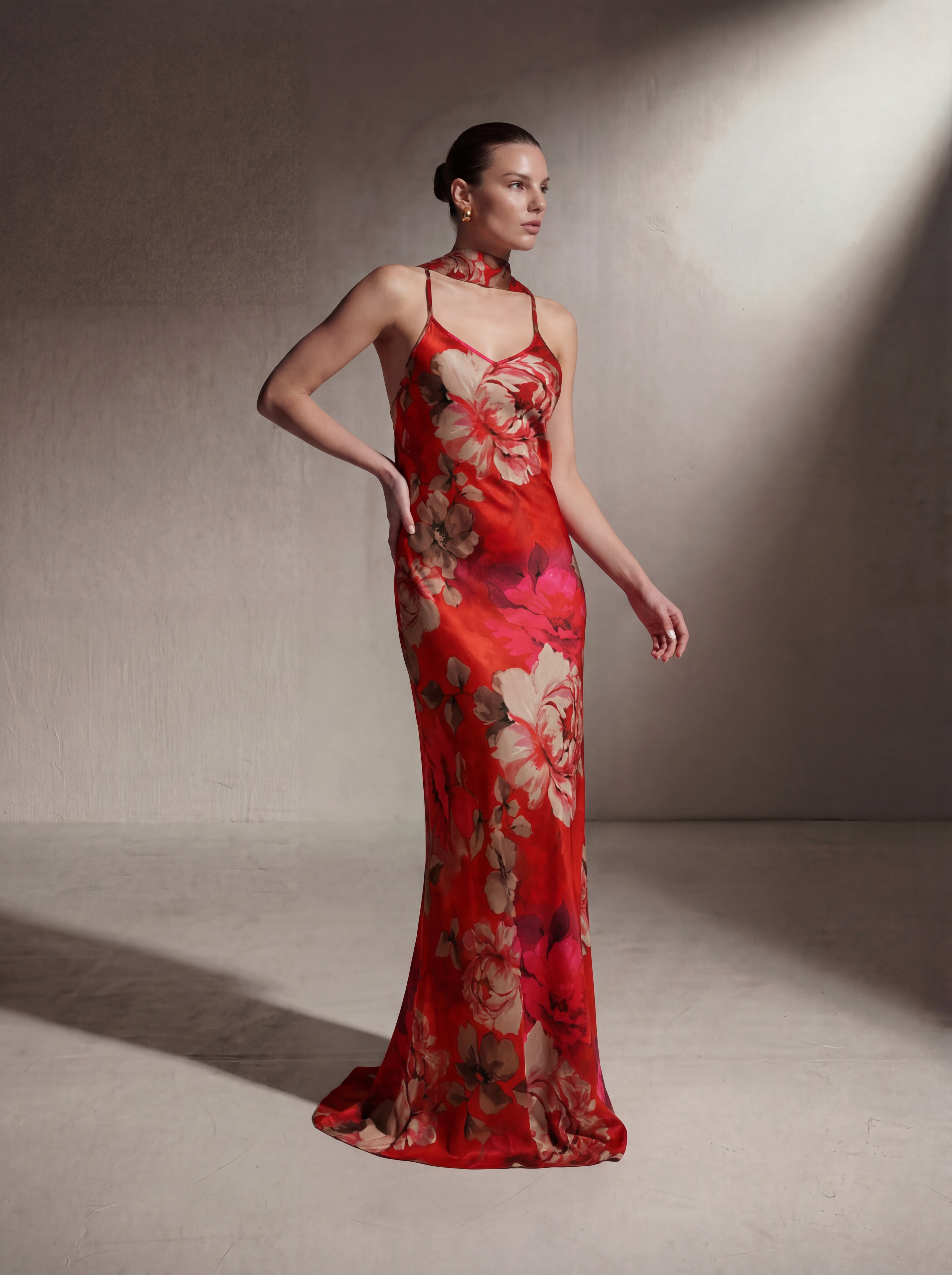 Woman wearing a Red Floral silk slip gown, front view