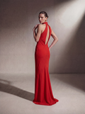 Woman wearing a Red silk halter gown, back view