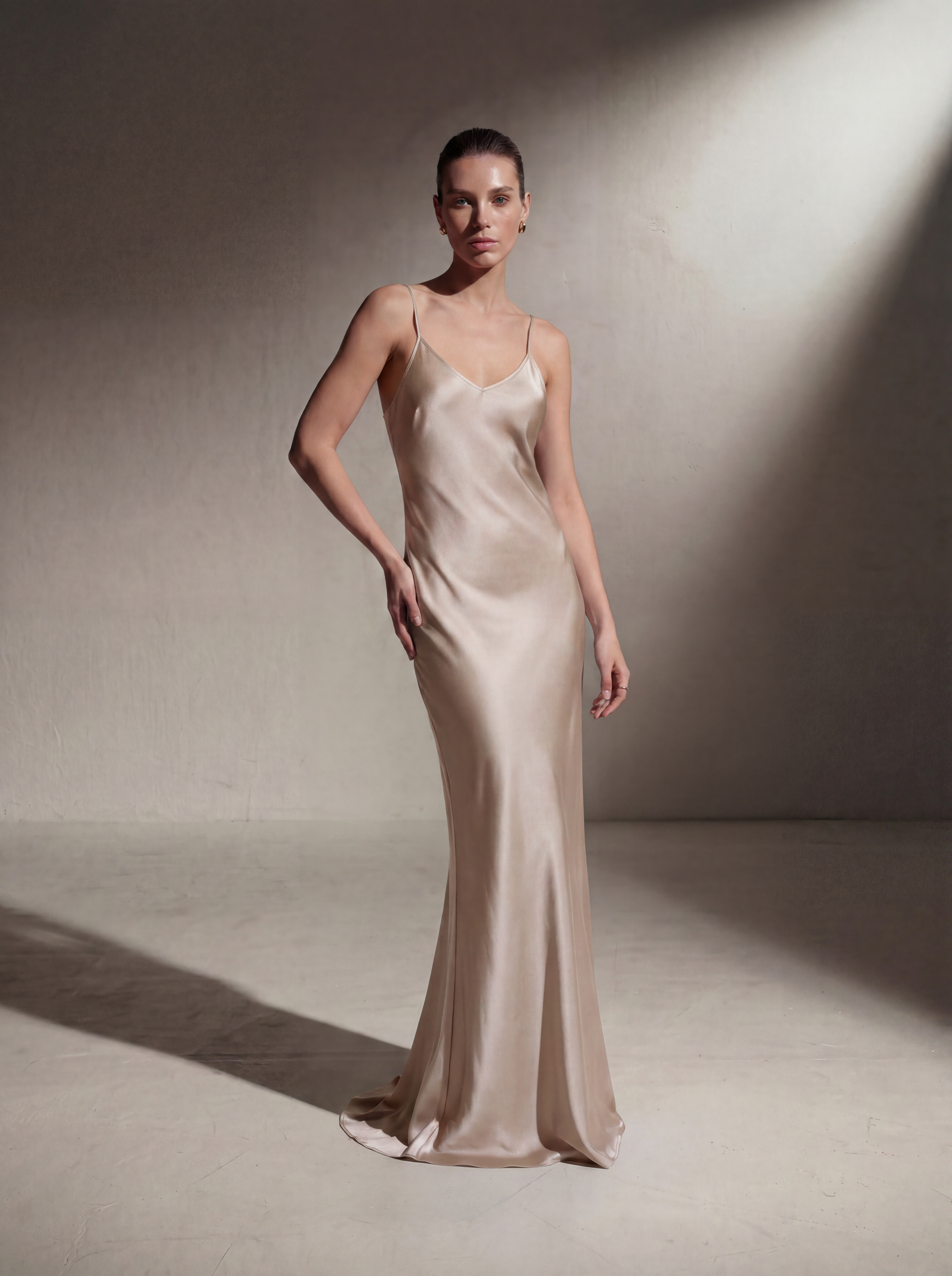 Woman wearing a Champagne silk slip gown, front view