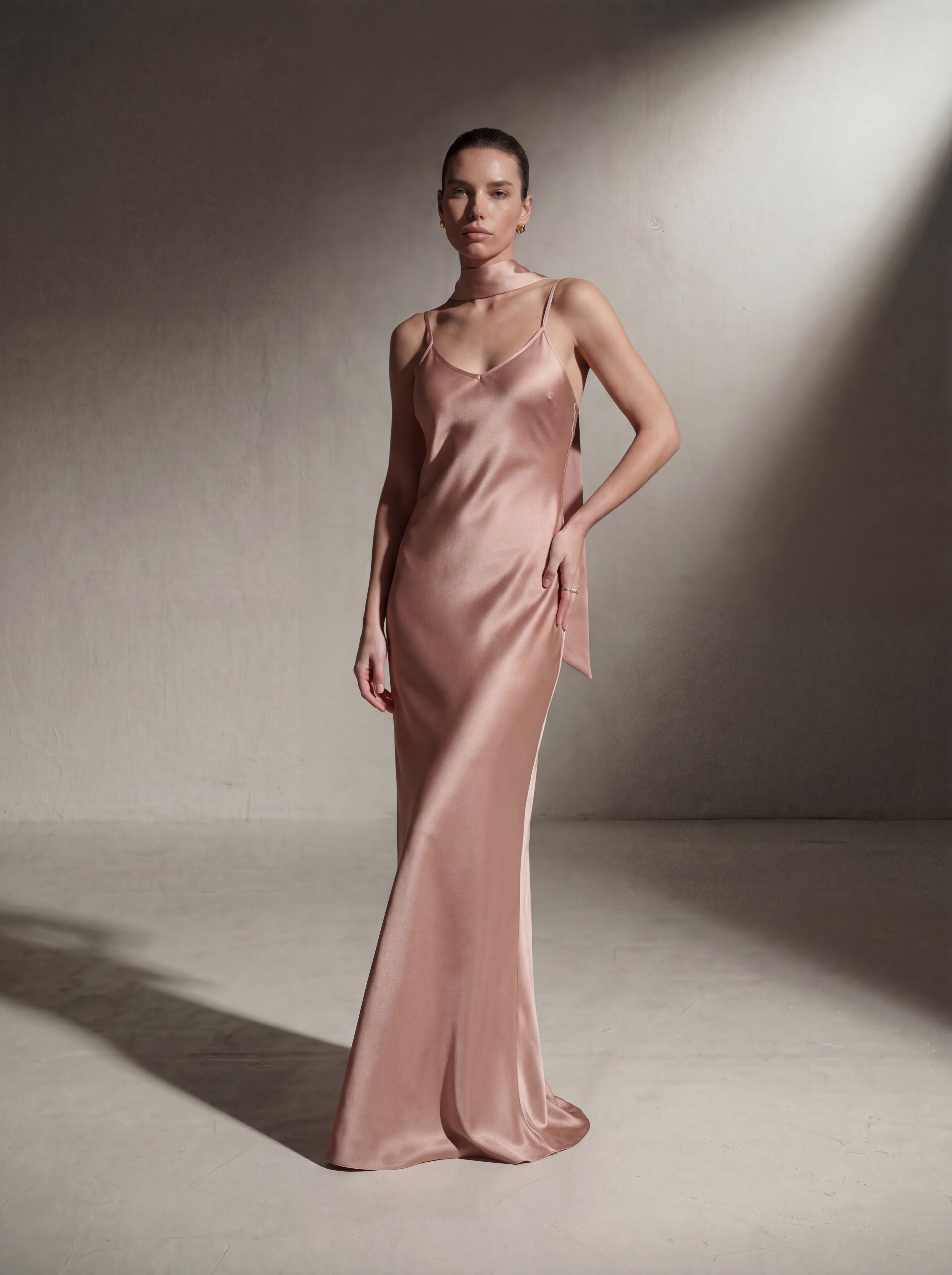 Woman wearing a Blush silk slip gown, front view